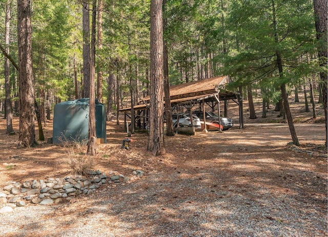 view of car parking with a wooded view