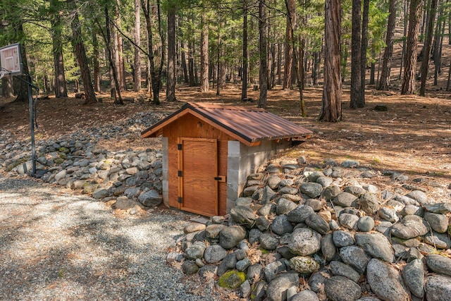 view of shed with a view of trees
