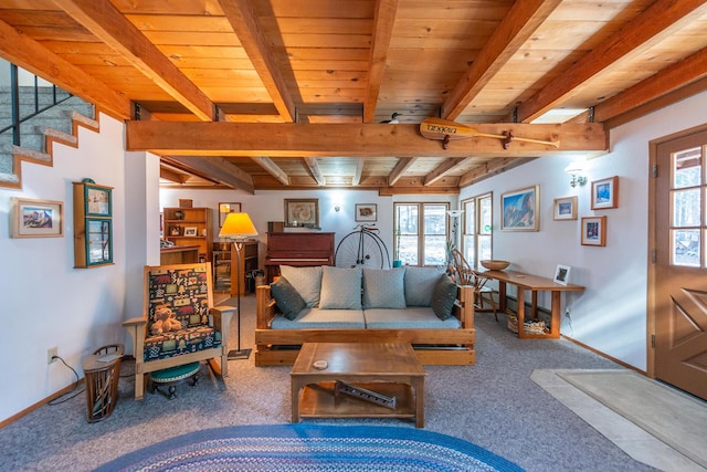 living area featuring carpet floors, beam ceiling, baseboards, and a wealth of natural light