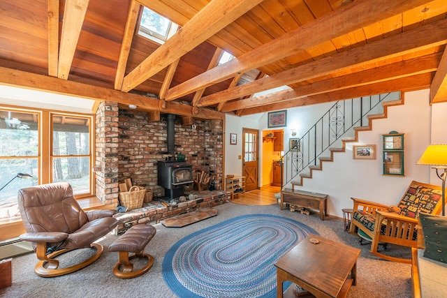 carpeted living area featuring stairway, wood ceiling, lofted ceiling with beams, and a wood stove
