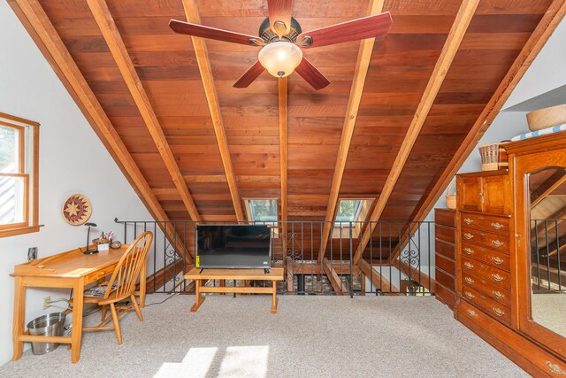 interior space with carpet floors, wooden ceiling, and vaulted ceiling with beams