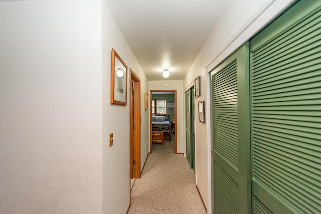 hallway featuring light carpet