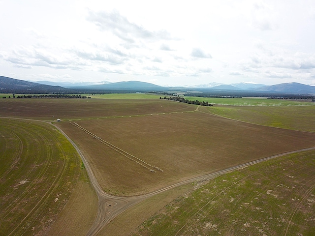 birds eye view of property featuring a mountain view and a rural view
