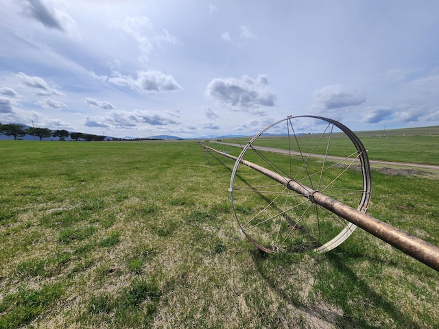 surrounding community featuring a yard and a rural view