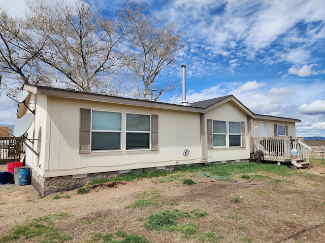 exterior space featuring crawl space and a wooden deck