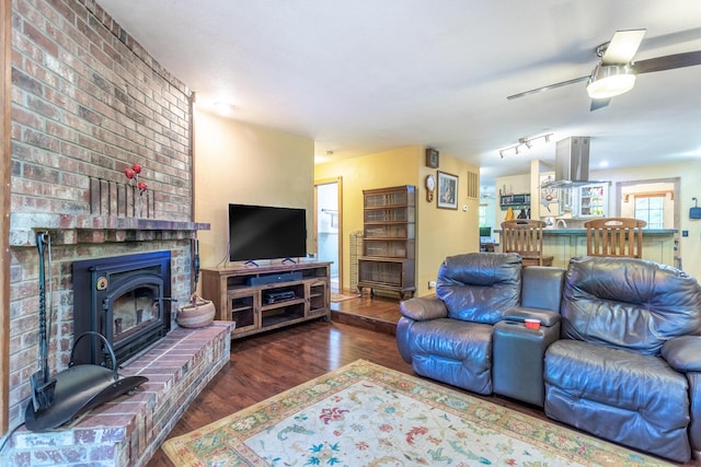 living area with a ceiling fan and wood finished floors