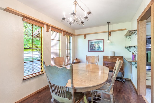 dining space with baseboards, a notable chandelier, and dark wood-type flooring