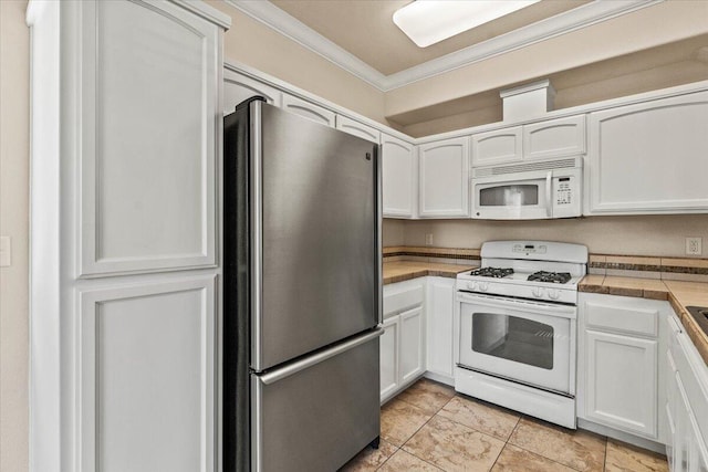 kitchen featuring white appliances, white cabinets, and ornamental molding