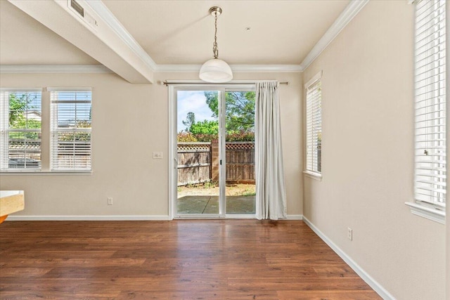 unfurnished dining area with baseboards, visible vents, ornamental molding, and wood finished floors