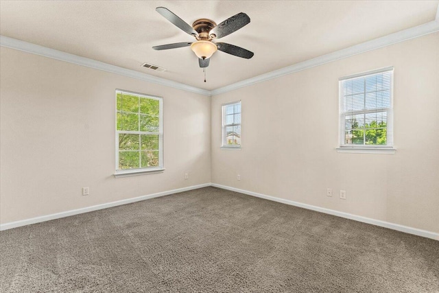 empty room featuring visible vents, baseboards, and crown molding