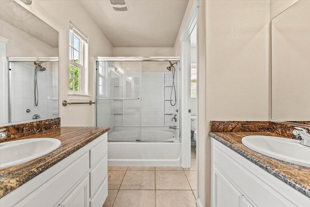 bathroom featuring a sink, toilet, and two vanities
