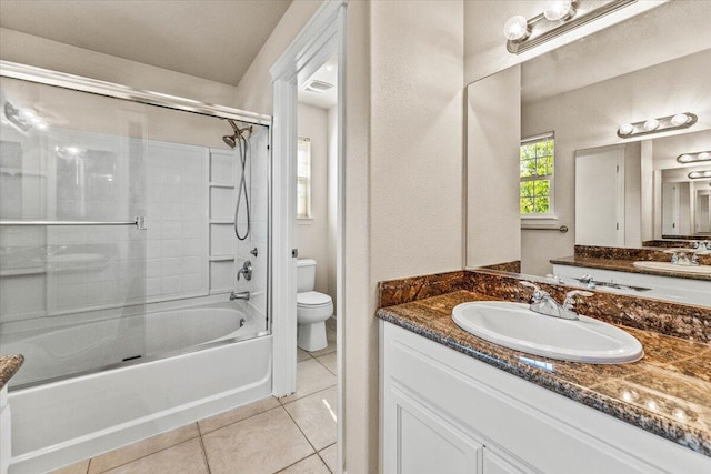 full bathroom with toilet, tile patterned floors, combined bath / shower with glass door, and vanity