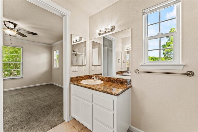 bathroom featuring crown molding, a ceiling fan, baseboards, and vanity