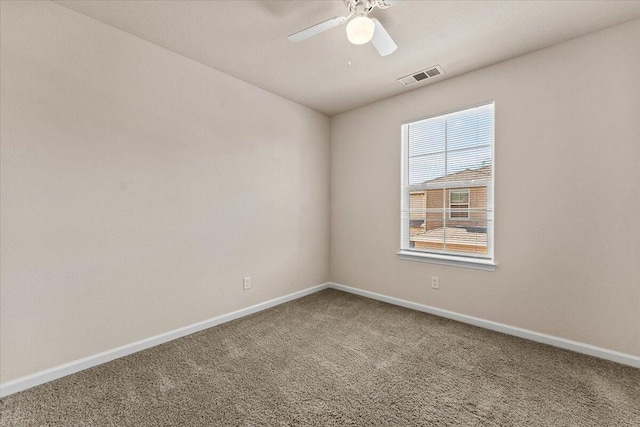 unfurnished room featuring baseboards, visible vents, ceiling fan, and carpet