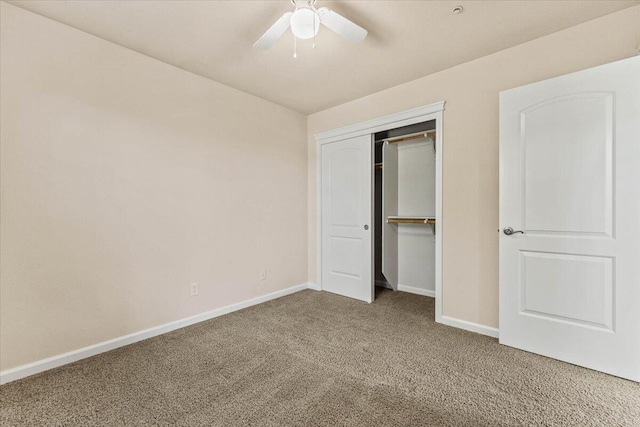unfurnished bedroom featuring carpet floors, baseboards, ceiling fan, and a closet