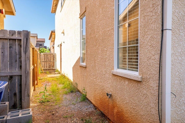view of home's exterior featuring fence and stucco siding