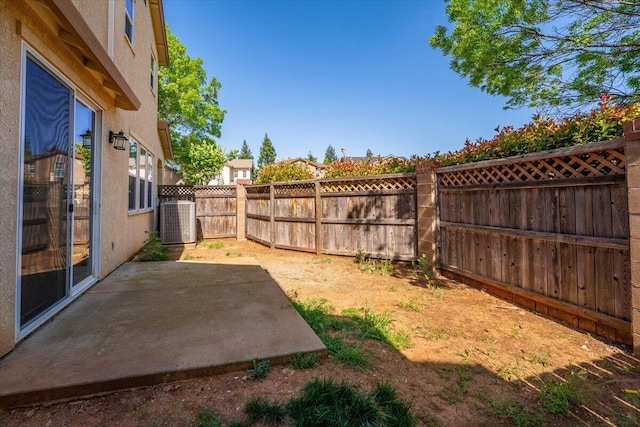 view of yard featuring a fenced backyard, a patio area, and cooling unit