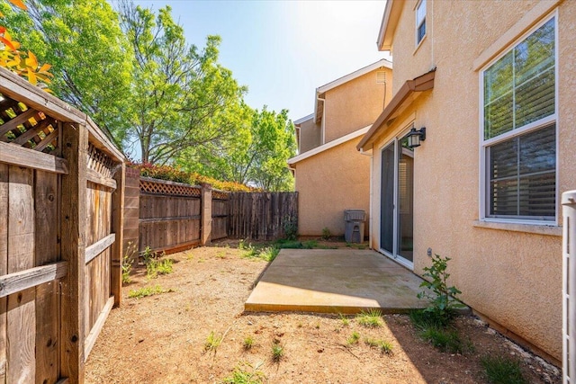 view of yard with a fenced backyard and a patio area