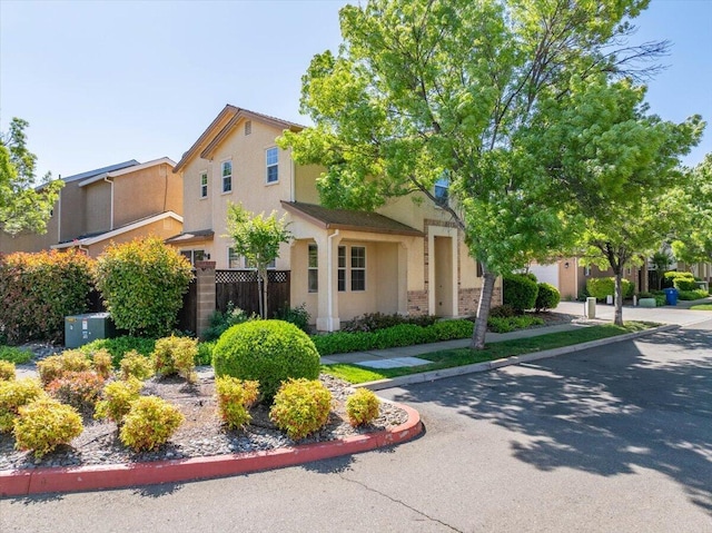 view of side of home featuring stucco siding and fence