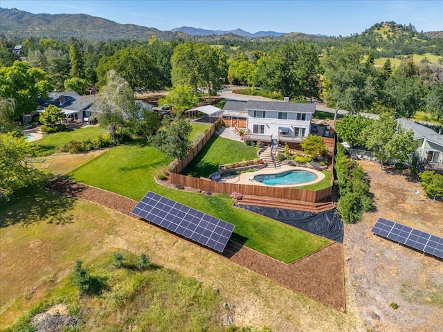 aerial view featuring a wooded view and a mountain view