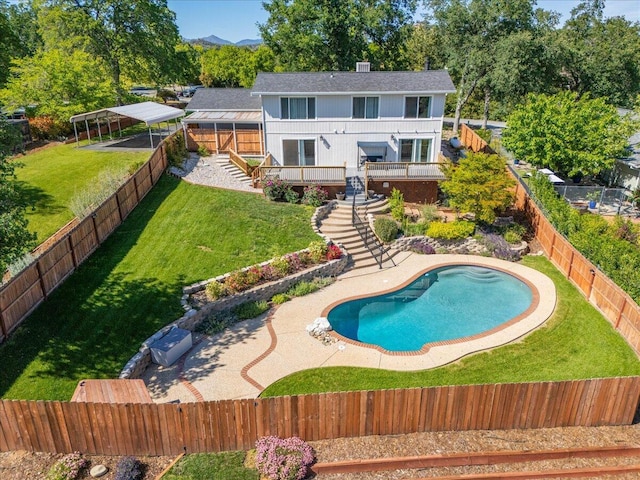 view of pool featuring a fenced backyard, stairs, a yard, and a wooden deck