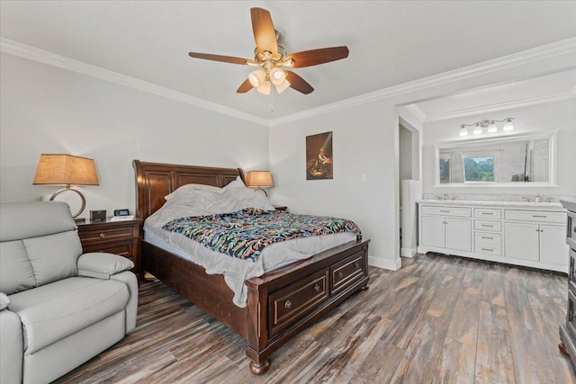 bedroom featuring baseboards, a sink, ornamental molding, and wood finished floors