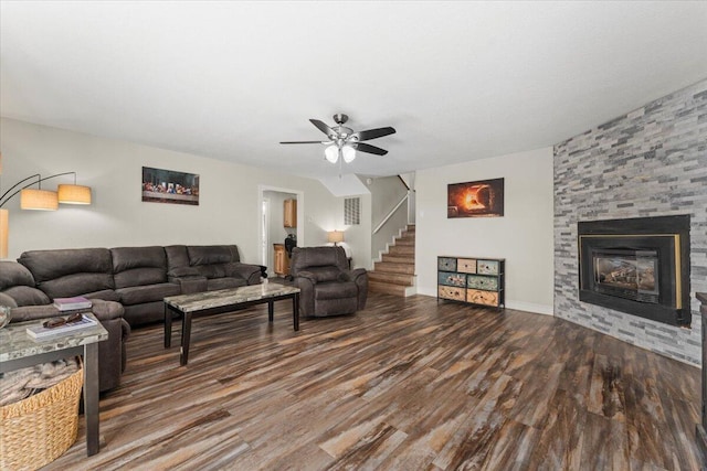 living room with ceiling fan, a fireplace, stairs, and wood finished floors