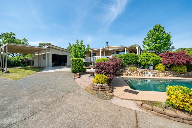 exterior space featuring a garage and an outdoor pool