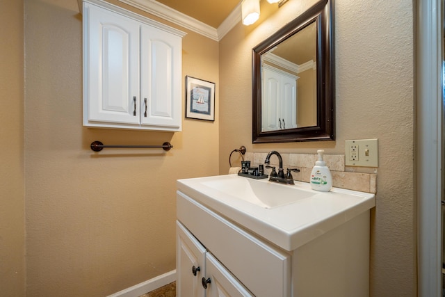 bathroom with vanity, ornamental molding, baseboards, and tasteful backsplash