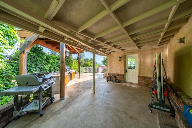 view of patio / terrace with exterior kitchen, area for grilling, and fence