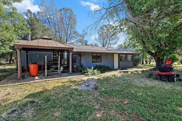 back of house featuring a gazebo, a yard, and a patio