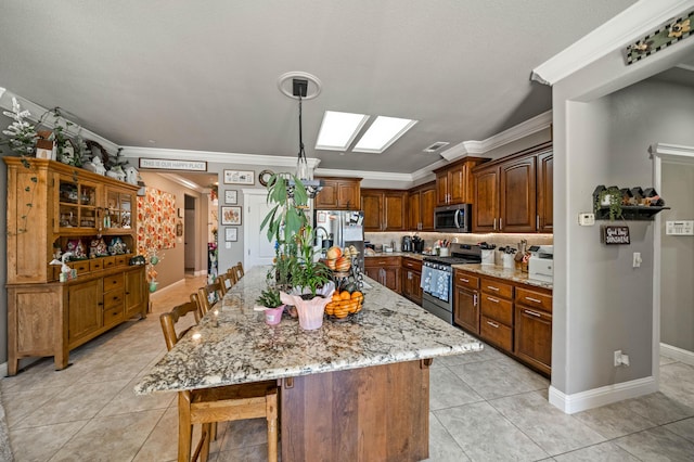 kitchen featuring stainless steel appliances, a breakfast bar, light stone counters, and light tile patterned floors