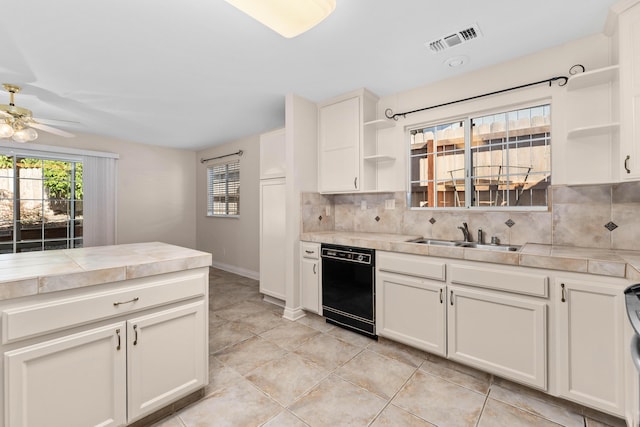kitchen with visible vents, open shelves, black dishwasher, a sink, and backsplash