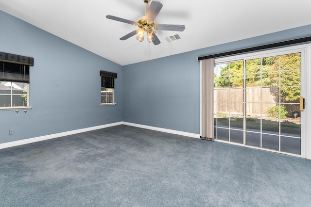 spare room with baseboards, a ceiling fan, dark carpet, and lofted ceiling