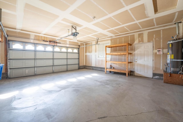 garage featuring a garage door opener and strapped water heater