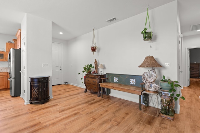 hall with baseboards, recessed lighting, light wood-style floors, and visible vents