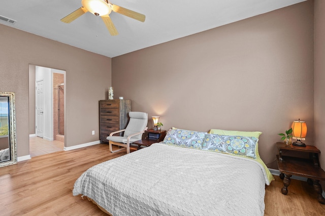bedroom with a ceiling fan, visible vents, wood finished floors, and baseboards