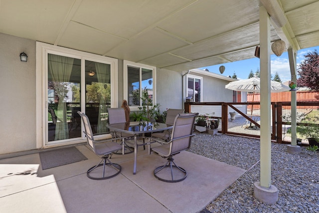 view of patio / terrace with outdoor dining area and fence