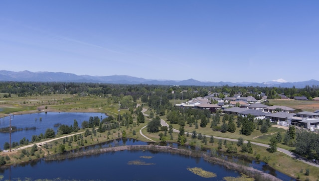 drone / aerial view with a water and mountain view