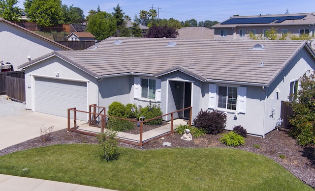 view of front of home featuring a tile roof, fence, an attached garage, and stucco siding