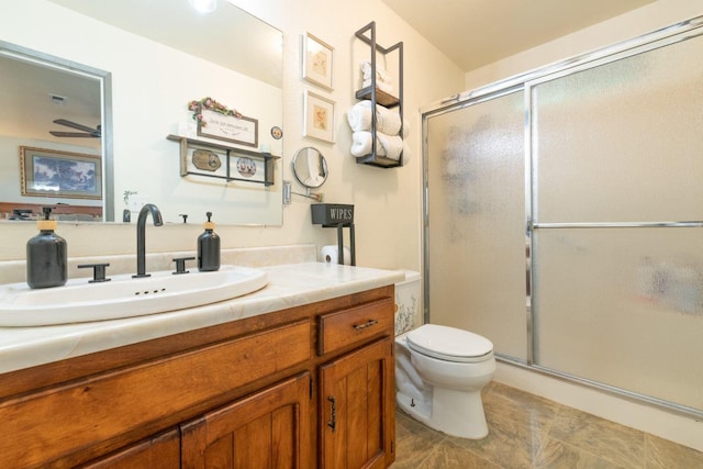 bathroom with tile patterned flooring, vanity, toilet, a ceiling fan, and a stall shower