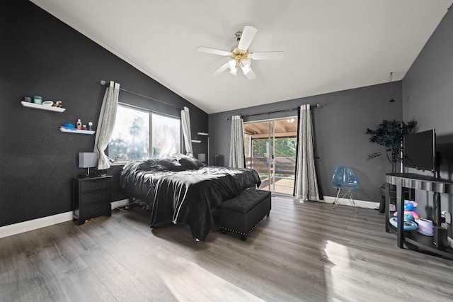 bedroom with wood finished floors, access to exterior, baseboards, a ceiling fan, and vaulted ceiling