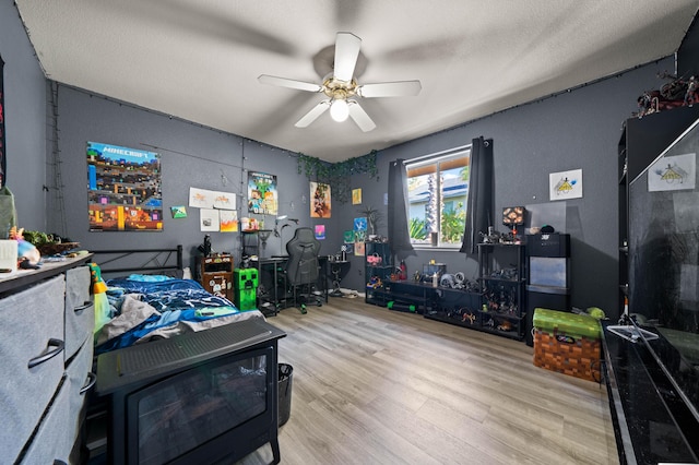 bedroom with a ceiling fan and wood finished floors