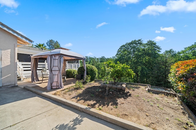 view of yard featuring a gazebo and a patio area