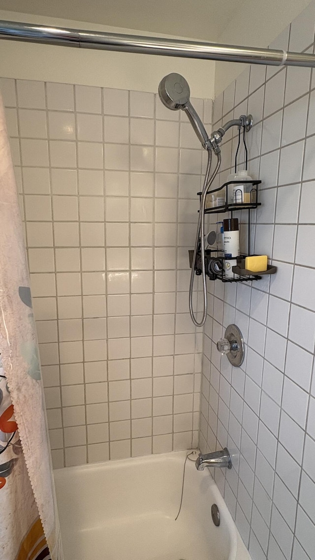 bathroom with shower / bath combination with curtain