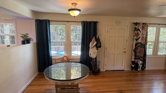 dining area featuring baseboards and wood finished floors