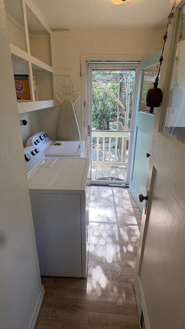 washroom with laundry area, wood finished floors, and washer and dryer