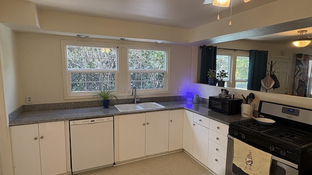 kitchen featuring black microwave, stainless steel range with gas stovetop, dishwasher, a sink, and white cabinets