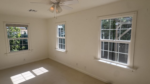 unfurnished room with baseboards, ceiling fan, and visible vents