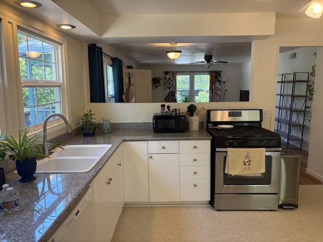 1020 E St, Redding, CA 96001 - kitchen featuring a sink, stainless steel gas stove, visible vents, black microwave, and white cabinets